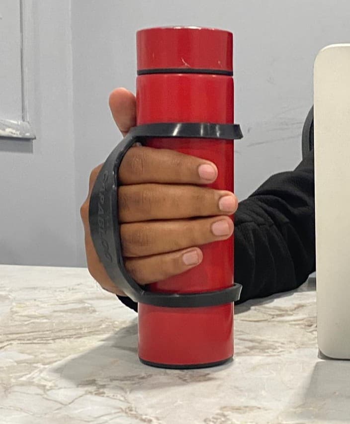 Capabloo Grip Assist on a bottle — ergonomic hand support in use
